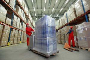 warehousing - workers in uniforms working in storehouse